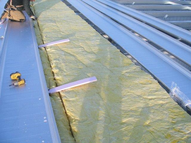 Roof panels installed and roof insulation down 